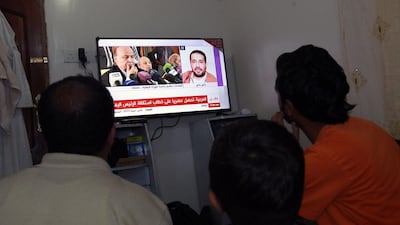 Yemenis watch the news in Sanaa on January 22, 2015, after President Abdrabu Mansur Hadi and the government tendered their resignations. Mohammed Huwais / AFP
