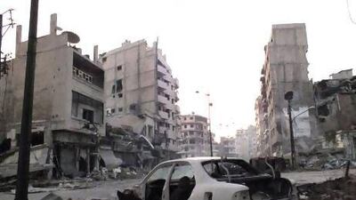 A damaged car in the Al Khalidiya neighbourhood of Homs. As the Syrian conflict continues, local city councils have taken on more of the responsibilities of running districts.