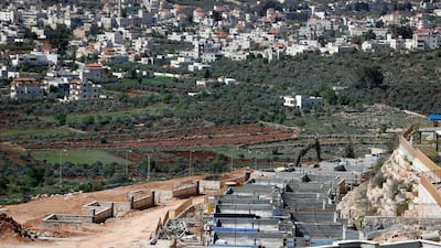 The Palestinian village of Turmus Ayya (background) faces houses under construction in the Jewish settlement of Shilo in the occupied West Bank between Ramallah and Nablus. The Israeli security cabinet gave its unanimous backing to the new settlement on March 30, 2017. Thomas Coex / Agence France-Presse