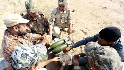 Members of Iraqi Shiite militia Imam Ali Brigades, which belongs to Shiite Popular Mobilization Forces, take rest during a live ammunition training exercise in Najaf city, Iraq. EPA