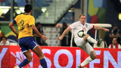 England’s Wayne Rooney, right, and Brazilian player Lucimar da Silva in action during the friendly international match in Doha, Qatar on Saturday November 14, 2009. Hanson K Joseph / AP Photo