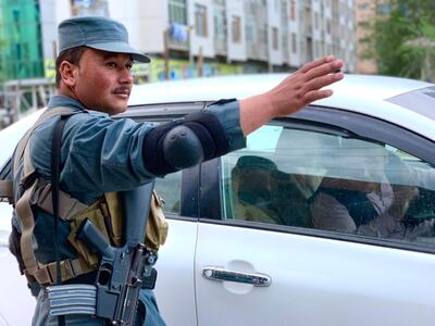 An Afghan policeman monitors traffic at a checkpoint in central Kabul. Hikmat Noori for The National