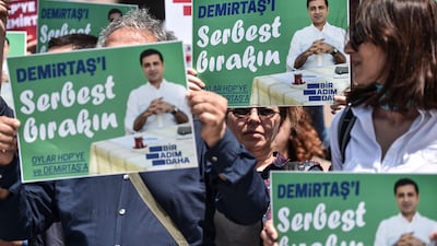 Supporters of the Peoples' Democratic Party (HDP) hold signs reading "Free Demirtas" in front of Istanbul's courthouse on May 21, 2018 to demand the release of party leader Selahattin Demirtas, who is running against Turkish President Recep Tayyip Erdogan in the June 24 elections. Ozan Kose / AFP