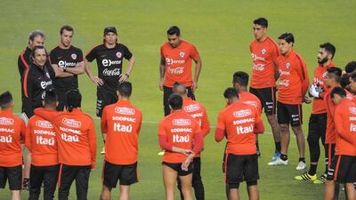 The Chile national football team listen to manager Juan Antonio Pizzi, left, at a training session on Tuesday. Jaime Echeverria / EPA