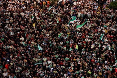 Syrians celebrate the launch of their new national emblem, in the west-central province of Hama. Reuters