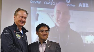 Andre Borschberg, Solar Impulse 2 co-pilot, meets the Aichi governor Hideaki Omura during a live television broadcast from Monaco of his co-pilot Bertrand Piccard, on screen, at Nagoya airport in Japan. Toshifumi Kitamura / AFP