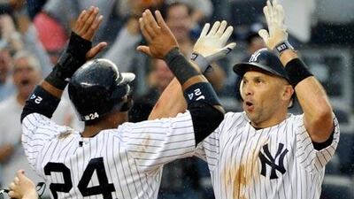 New York Yankees' Raul Ibanez, right, celebrates with Robinson Cano.