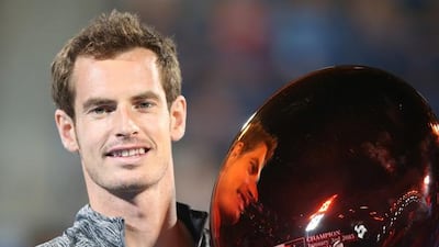 Andy Murray poses with the winners trophy after Novak Djokovic pulled out of the final match on Saturday in Abu Dhabi. Ali Haider / EPA
