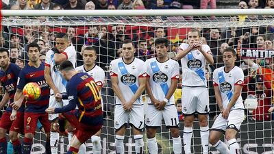 Barcelona’s Argentinian striker Lionel Messi (front) scores the 1-0 goal during the Spanish Liga Primera Division soccer match between FC Barcelona and Deportivo Coruna played at Camp Nou stadium, in Barcelona, Spain, 12 December 2015. EPA/Quique Garcia