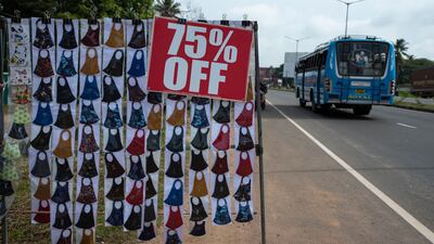 Face masks are displayed for sale by the side of a highway in Kochi, Kerala state, India, Monday, Sept. 20, 2021. The tiny southern state continues to battle the highest number of coronavirus cases in the country. (AP Photo / R S Iyer)