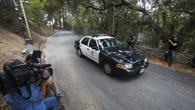 A police car the entrance to Demi Moore's Beverly Hills home. Coroner’s officials say a 21-year-old man accidentally drowned in her swimming pool. Ringo HW Chiu / AP Photo