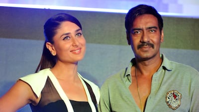 Bollywood actors Kareena Kapoor Khan (L) and Ajay Devgn during a promotional event for the 2014 Hindi film 'Singham Returns.' AFP