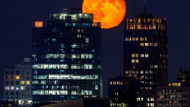 The waning gibbous moon, a phase between a full moon and a half moon, rises above Berlin's Potsdamer Platz. AFP