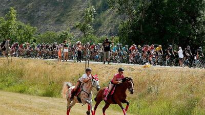 Horseback riders pace the peloton during Stage 17 of the Tour de France on Wednesday in Allos, France on the way to Pra Loup. Doug Pensinger / Getty Images