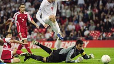 Peter Crouch, right, prods home a goal as England rout Andorra 6-0 at Wembley on june 10.