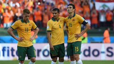 Australia's midfielder Oliver Bozanic, left, Australia's forward Tim Cahill, centre, and Australia's midfielder and captain Mile Jedinak react at the end of a Group B football match between Australia and the Netherlands at the Beira-Rio Stadium in Porto Alegre during the 2014 FIFA World Cup on June 18, 2014. AFP PHOTO / WILLIAM WEST