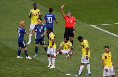 Referee Damir Skomina from Slovenia shows a red card to Colombia's Carlos Sanchez Moreno, on the ground, during their defeat to Japan on Wednesday. Vadim Ghirda / AP Photo