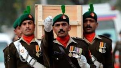 Soldiers carry a coffin during the funeral of the victims of Friday's mosque attack in Rawalpindi.