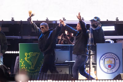 Liam, left, and Noel Gallagher of Oasis salute fans of the band on stage in 2025. Getty Images