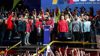 Venezuela's President Nicolas Maduro raises a finger as he is surrounded by supporters while speaking during a gathering after the results of the election were released, outside of the Miraflores Palace in Caracas, Venezuela. Carlos Garcia Rawlins / Reuters