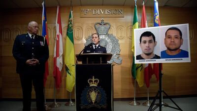 Assistant Commissioner Rhonda Blackmore speaks while Regina Police Chief Evan Bray, left, looks on during a press conference at RCMP "F" Division Headquarters in Regina, Saskatchewan, on Sunday, Sept. 4, 2022. Damien Sanderson and Myles Sanderson allegedly stabbed and killed 10 people between James Smith Cree Nation and Weldon, Saskatchewan, on Sunday morning, and the pair are presently at large. (Michael Bell / The Canadian Press via AP)