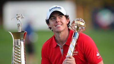 Rory McIlroy with the DP World Tour Championship and Race to Dubai trophies after winning the tournament, and European Tour money list, in 2012. Pawan Singh / The National