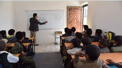 A before-and-after photo of a school in Sanaa showing students sitting on the floor as a teacher writes on a small white board hung on a brick wall. After working with a charity group in Kuwait, Ali helped re-vamp the classroom into a fully-functioning hall with desks, chairs, painted walls and a bigger white board. Ali Alsonidar