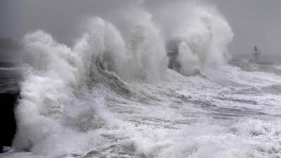 Waves hit a jetty in western France as Storm Ciara sweeps across western Europe. AFP