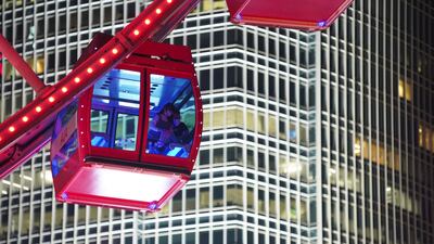 Visitors look at the view from inside the observation wheel in Hong Kong, China. Reuters