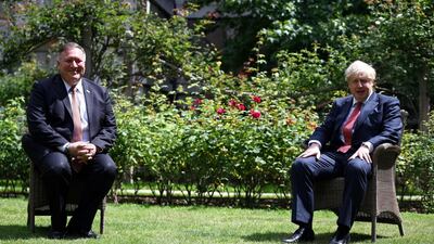 US Secretary of State Mike Pompeo, left, and UK Prime Minister Boris Johnson sit in the garden of No 10 Downing Street on July 21. AFP