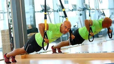 Guillaume Mariole of the Ignite Fitness and Wellness Club in Dubai demonstrates how the TRX straps can be used.