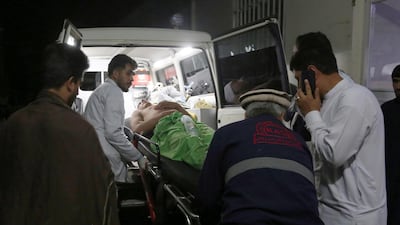A wounded man is carried to a hospital after an explosion at wedding hall in Kabul, Afghanistan. AP