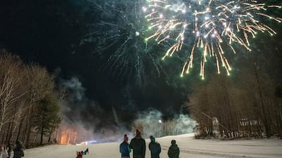 Sunday River guests watch the fireworks display on the side of the ski trails to ring in the New Year in Newry, Maine. All festivities stopped promptly at 9 PM in accordance with state guidelines. AP Photo