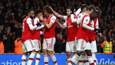 Reiss Nelson of Arsenal (2L) celebrates with his team mates after scoring the winner. Getty