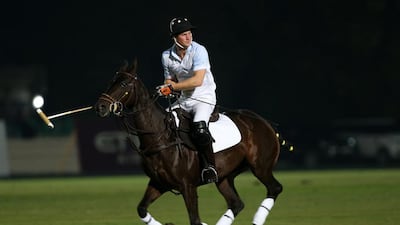 Prince Harry plays for the Sentebale Huntsman team against St Regis at Ghantoot Racing & Polo Club. Pawan Singh / The National