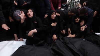 Palestinians mourn relatives killed in the Israeli bombardment of the Gaza Strip, outside a morgue in Khan Younis. AP