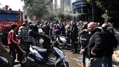 A large group of protestors had gathered around the vandalised bank. AFP
