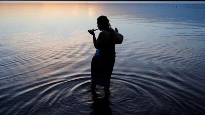 Activist Winona Laduke lights a pipe during a multi-faith sunset prayer at Northern Pines Camp as part of the Treaty People Gathering, an organized protest of the Line 3 pipeline, Minnesota, the US. Reuters