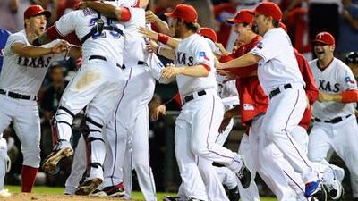 The Texas players mobbed the field in celebration after winning Game 6 of the American League Championship Series to eliminate the Detroit Tigers and reach the World Series for the second consecutive year.