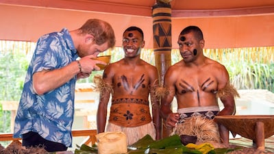 Prince Harry smells a bowl of kava as Joeli Nasqqa, centre, and Eparama Uluiuiti, right, watch during a dedication of the Colo-i-Suva forest to the Queen's Commonwealth Canopy in Suva, Fiji. Dominic Lipinski via AP
