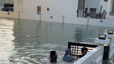 The determined volunteers swim through waters to help residents of badly flooded homes. Photo: Jamal Al Janahi