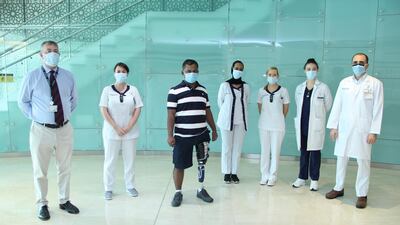 Hashan Ali and his doctors at Cleveland Clinic Abu Dhabi. The Bangladeshi shop worker was fitted with a prosthetic leg and underwent physiotherapy. Courtesy: Cleveland Clinic Abu Dhabi