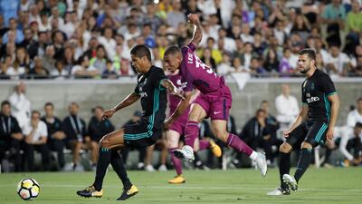 Manchester City's Gabriel Jesus, centre, shoots under pressure from Real Madrid's Raphael Varane. Jae C Hong / AP Photo