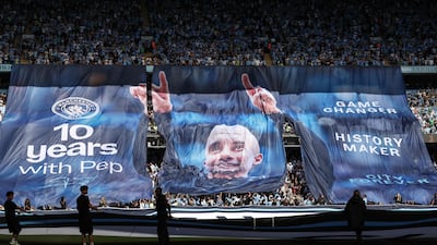 Supporters hold up banners at the Etihad Stadium on Sunday. AFP