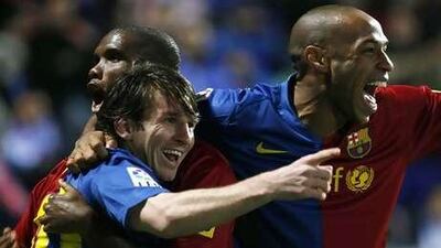 Lionel Messi, left, celebrates with teammates Thierry Henry, right, and Samuel Eto'o.
