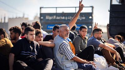 A Palestinian man flashes the victory sign as he and others leave northern Gaza before an expected Israeli ground offensive. AFP