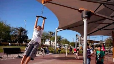 At left, 12-year-old Ali al Qubaisi plays with his friends in a children's playground in Al Bateen, one of several new parks in Abu Dhabi.