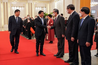 Ferdinand Marcos Jr shakes hands with Chinese officials in the presence of President Xi Jinping in Beijing, also in February. AFP