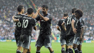 Chelsea's Diego Costa celebrates with teammates after his goal put the team 2-0 up against West Brom on Sunday in their 3-2 win in the Premier League. Will Oliver / EPA