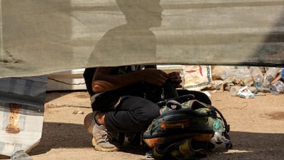 A young Iranian pilgrim waits at the Al-Shalamija border crossing, west of the southern Iraqi city of Basra, before crossing to Iraq to mark the Arbaeen religious festival, on September 25, 2021, follwoing the reopening of the border that was shut due to the coronavirus pandemic. - Every year, Shiite pilgrims converge in large numbers to the holy Iraqi cities of Najaf and Karbala ahead of Arbaeen, which marks the 40th day after Ashura, commemorating the seventh century killing of Prophet Mohammed's grandson Imam Hussein. (Photo by Hussein FALEH / AFP)